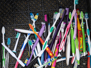 Used toothbrushes are collected for disposal. Separate garbage collection. Waste sorting. A lot of old toothbrushes are in the drawer.