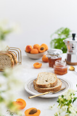 Beautifully served summer breakfast with toasted bread and homemade apricot jam