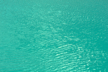 Bright, colorful background close up, turquoise green water surface lake, outdoors.