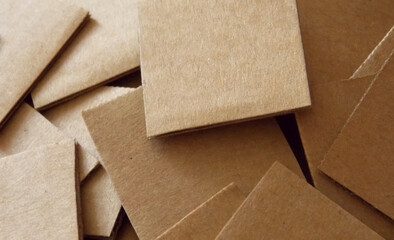 Scattered square pieces of cardboard close up