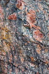 Background with natural rough granite stone, solid colorful texture. Close-up photo. Nature, outdoors.