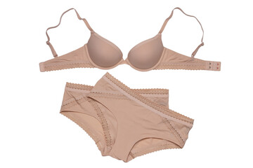 Women lingerie isolated. Close-up of beige or flesh-colored bra and two panties isolated on a white background. Useful for wearing under bright or transparent dresses. Underwear fashion.