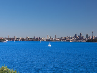 Fototapeta premium Panoramic view of Sydney Harbour in NSW Australia on a cold winters day blue skies with CBD in the background