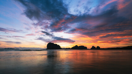 Fototapeta na wymiar Twilight sky with beach and mountains at Pakmeng beach, Trang, Thailand