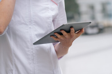 closeup of a medical professional using a digital tablet.