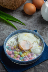 Thai dessert called Bualoy balls in dippers with hot coconut milk and pandan leaves to increase the deliciousness.