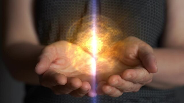 Woman hands creating energy sphere. Accumulation and retention of vital energy. Magical power in hands. Qi gong practicing