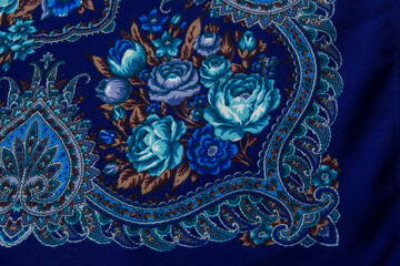 flat lay top view closeup part of blue rose floral pattern on dark cotton female shawl