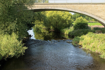 Fototapeta premium View from the Nidderdale Greenway of The River Nidd and the bridge between Ripley and Killinghall, North Yorkshire, UK.
