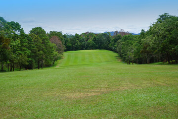 Background of evening golf course has sunlight shining down at golf course in Thailand. Nice scenery on a golf course at a late summer afternoon