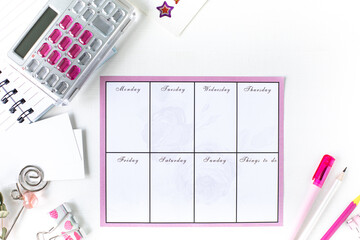 Fototapeta premium Glider with notes and to-do list on a white background with pink stationery. Business concept