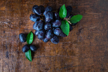 .Black grapes in a basket on a wooden table