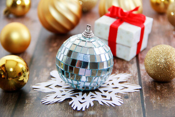 Fototapeta na wymiar shiny toy ball for Christmas tree and white a snowflake