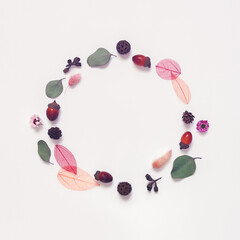 Autumn composition. The wreath is made from dried leaves, flowers, plants and acorns. Minimalistic autumn concept. Flat lay, top view, copy space.