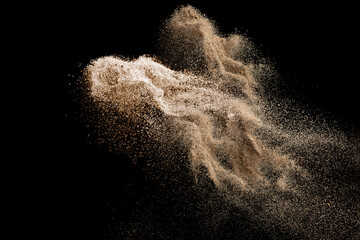 Abstract sand explosion art on black background, sand splash.
