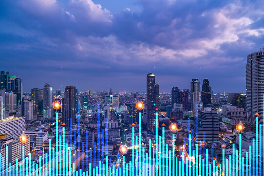Stock market graph hologram, night panorama city view of Bangkok, popular location to gain financial education in Asia. The concept of international research. Double exposure.