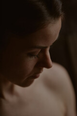 Obraz premium A girl with black hair in black underwear lies on the floor