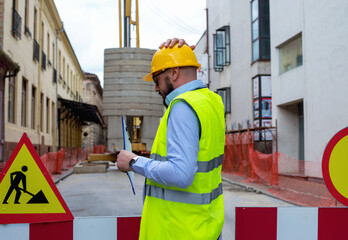 Stressed  Construction engineer works on the site