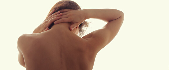 Beautiful sporty strong nude woman touching and massaging the neck with pain .Healthy tanned skin....