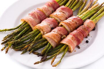Green asparagus wrapped with bacon isolated on white background