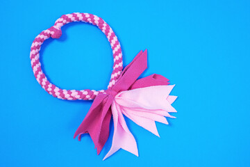 Cute pink fabric tug-of-war toy for dogs with rope handle for fun and games with beloved pet on...