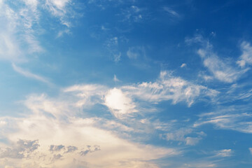 Dark blue sky with pink clouds and the light of the setting sun.