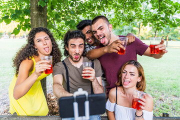 multiethnic group of millennial friends take a selfie celebrating a birthday