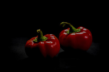 Red bell peppers on dark background