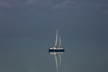 A beautiful sky with a boat in the sea with clouds over