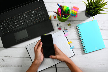 Young businesswoman working with digital tablet computer and smart phone. hands touching on digital...