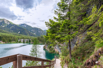 Walking path along the shores of the famous Braies Lake in the Italian Alps