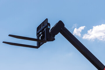 pitchfork manipulator in the background of clouds performing loading works