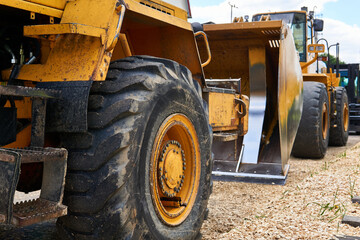 row of standing heavy construction equipment close up