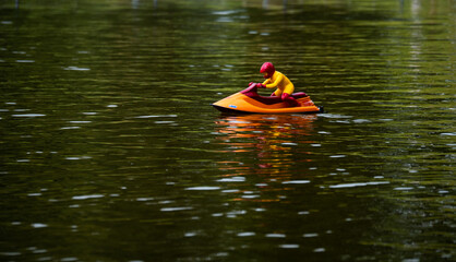 RC controlled jet ski model on lake. Active summer vacation for school child.