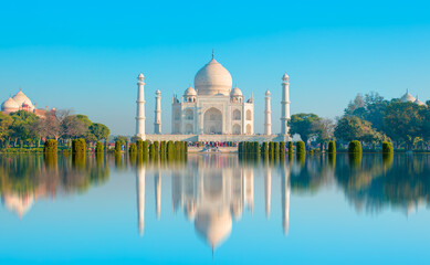 Fototapeta na wymiar Panoramic view of Taj Mahal during bright blue sky reflected in water - Agra , Uttar Pradesh, India