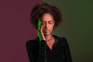 Beautiful young african american woman over isolated background touching mouth with hand with painful expression because of toothache or dental illness on teeth. Dentist concept