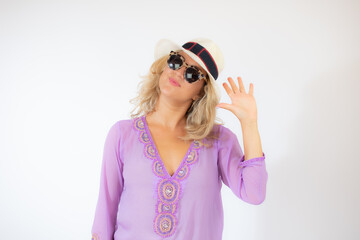 Pretty blonde woman wearing sunglasses and with a lilac caftan