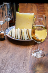 Spanish fino sherry wine from Andalusia and pieces of different sheep hard manchego cheeses made in La Mancha, Spain. Wine and cheese pairing