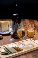 Spanish fino sherry wine from Andalusia and pieces of different sheep hard manchego cheeses made in La Mancha, Spain. Wine and cheese pairing