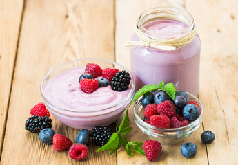 Fresh berry fruit yogurt with forest fruits and mint