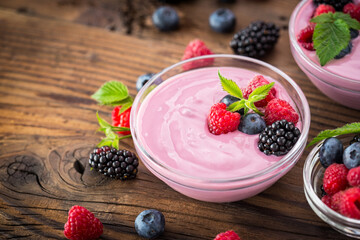 Fresh berry fruit yogurt with forest fruits and mint