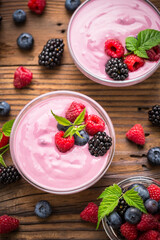 Fresh berry fruit yogurt with forest fruits and mint