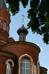 Fototapeta na wymiar Orthodox old Church of red brick, close.