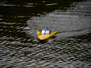 RC controlled jet boat model on lake. Active summer vacation for school child.