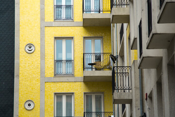 Fototapeta na wymiar Nice yellow tile facade of residential building with many balconies and windows in the city center of Porto Portugal