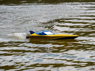 RC controlled jet boat model on lake. Active summer vacation for school child.