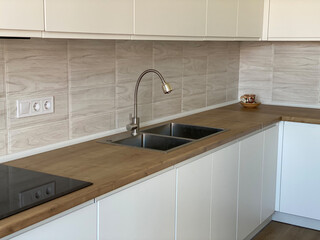 Stylish modern kitchen interior - cabinets sink refrigerator