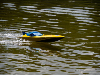 RC controlled jet boat model on lake. Active summer vacation for school child.
