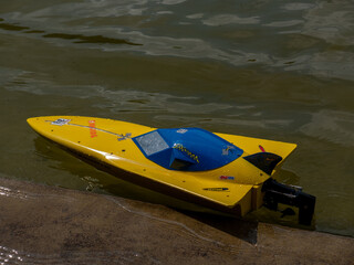 RC controlled jet boat model on lake. Active summer vacation for school child.