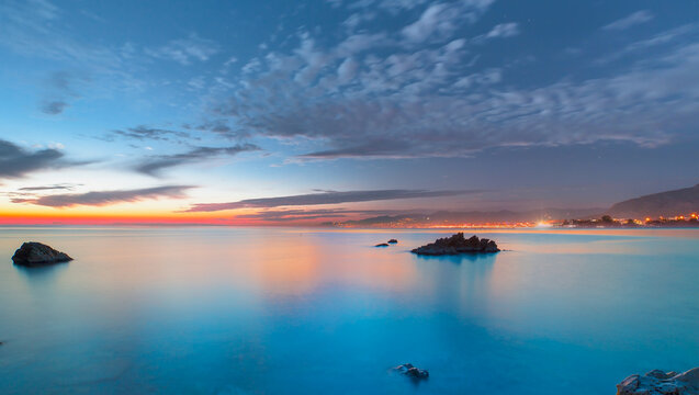 Long exposure image of dramatic sky and seascape with rock at sunset - Alanya, Turkey